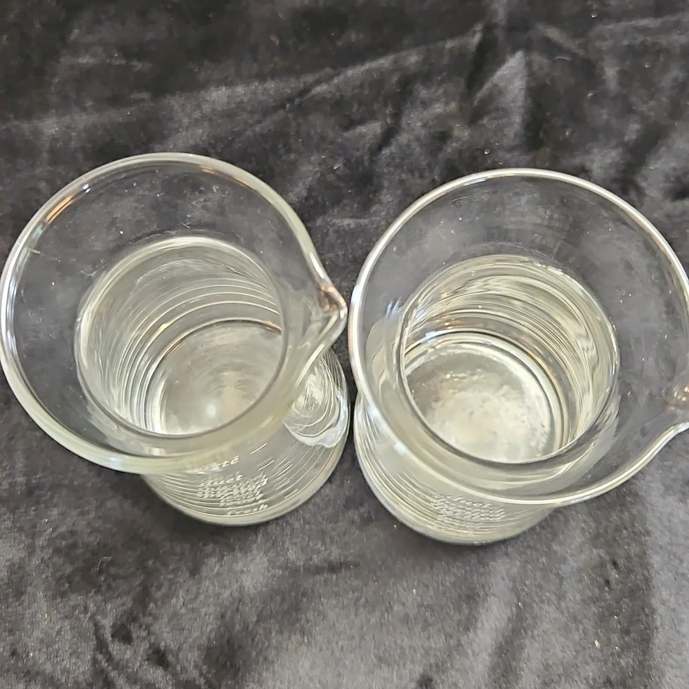 Set of 2 mini decanter or small measuring glass likely for wine or other liquids